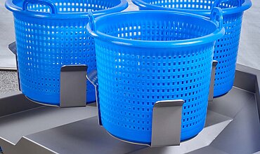 Easily stackable plastic baskets which are placed into the spin-dryer